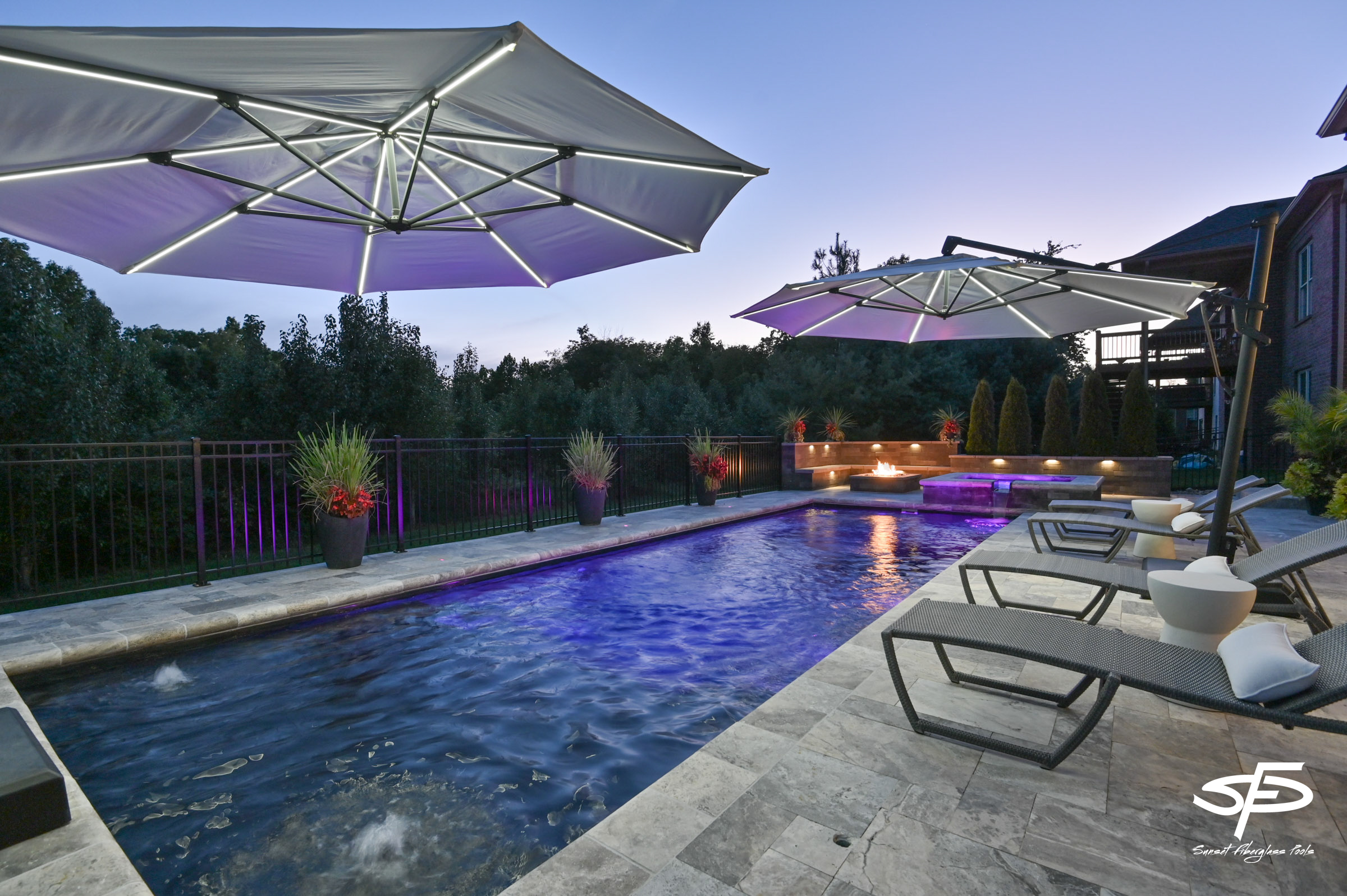 evening pool with lighting and fire pit