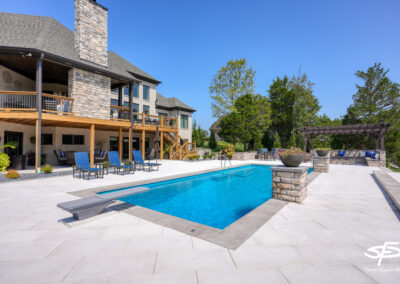pool with diving board and patio