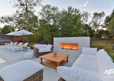 luxurious white outdoor fireplace and patio